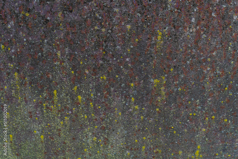Painted iron surface with a large rusty, black spot and metal corrosion. Old background with peeling and cracking paint. Painted iron surface with a large rusty, black spot and metal corrosion. Old background with peeling and cracking paint.