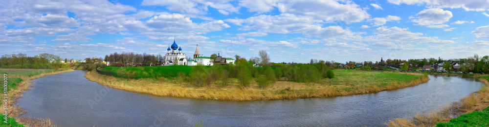 Suzdal, Vladimirovskaya oblast, Russia, 05.08.2022. The bend of the Kamenka River. Assumption Cathedral and bell tower on the horizon, Russian architecture of the XIII century