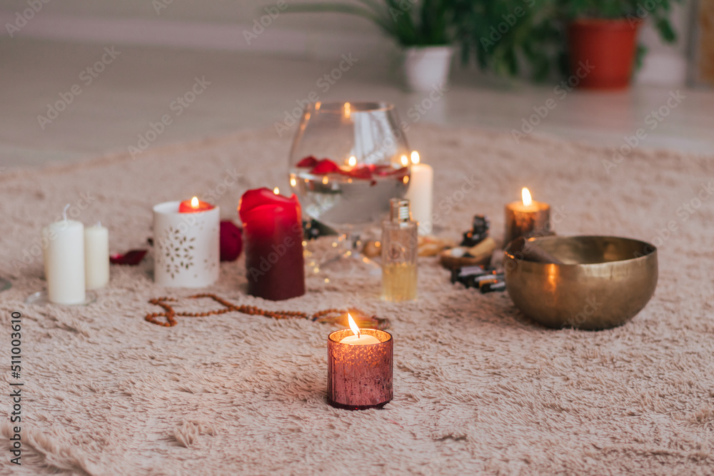 The atmosphere of relaxation meditation lit candles red rose petals essential lie soft fluffy carpet The atmosphere of relaxation meditation lit candles red rose petals essential lie soft fluffy carpet