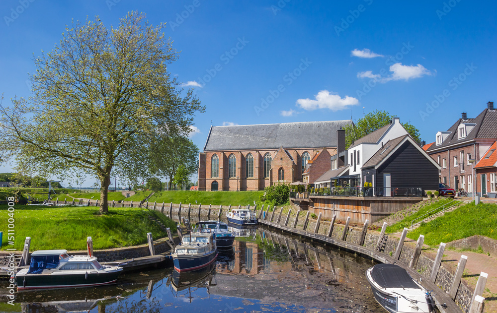 Houses, boats and reformed church at the inner harbor of Vollenhove, Netherlands