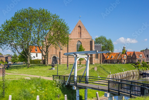Small white bridge and historic church in the old harbor of Vollenhove, Netherlands photo