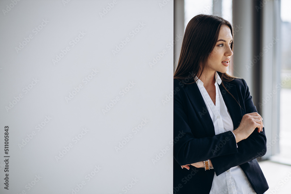 Business woman standing in office in formal wear Business woman standing in office in formal wear