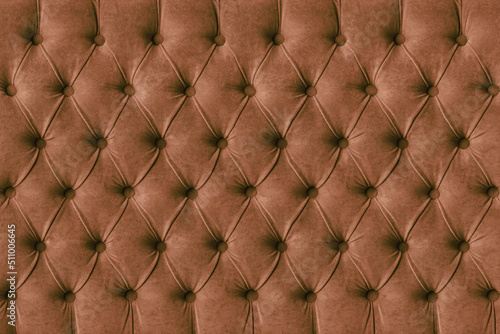Brown capitone checkered soft fabric textile decorative background with buttons. Classic retro Chesterfield style, luxurious upholstery buttoned texture for furniture, wall, headboard, sofa, couch