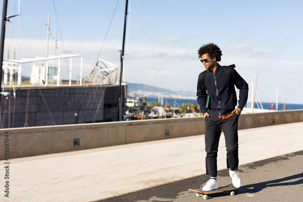 Handsome man with skateboard. Young smiling man having fun outdoors.