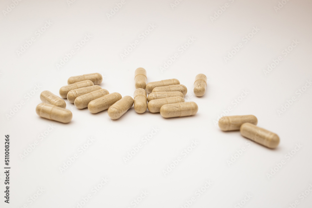 Pills with the badas, dietary supplement on a white background Pills with the badas, dietary supplement on a white background