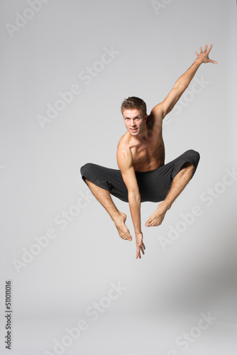 Wallpaper Mural modern ballet male dancer posing over white studio background Torontodigital.ca
