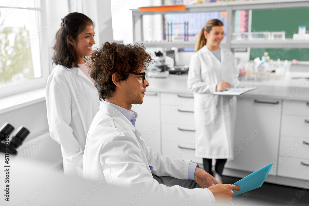 science, work and people concept - international group of happy scientists in laboratory science, work and people concept - international group of happy scientists in laboratory