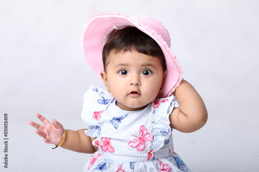 Indian baby girl sitting on white background. Indian baby girl sitting on white background.