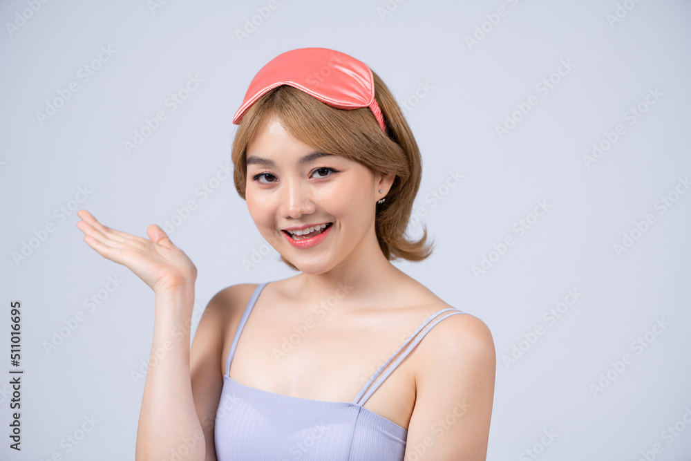 Studio shot of pleased beautiful young woman posing in eyemask. Studio shot of pleased beautiful young woman posing in eyemask.