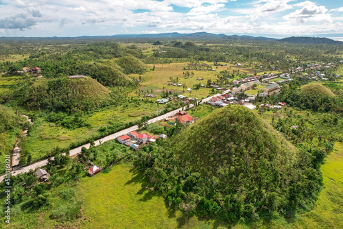 A highway cuts through some of the world famous Chocolate Hills in the town of Sagbayan, Bohol. photo