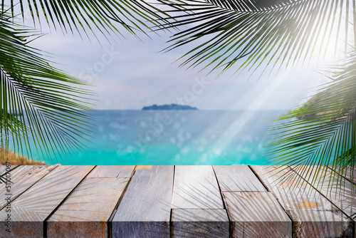 Wood table top and blurred summer beach and sky background, can used for display or montage