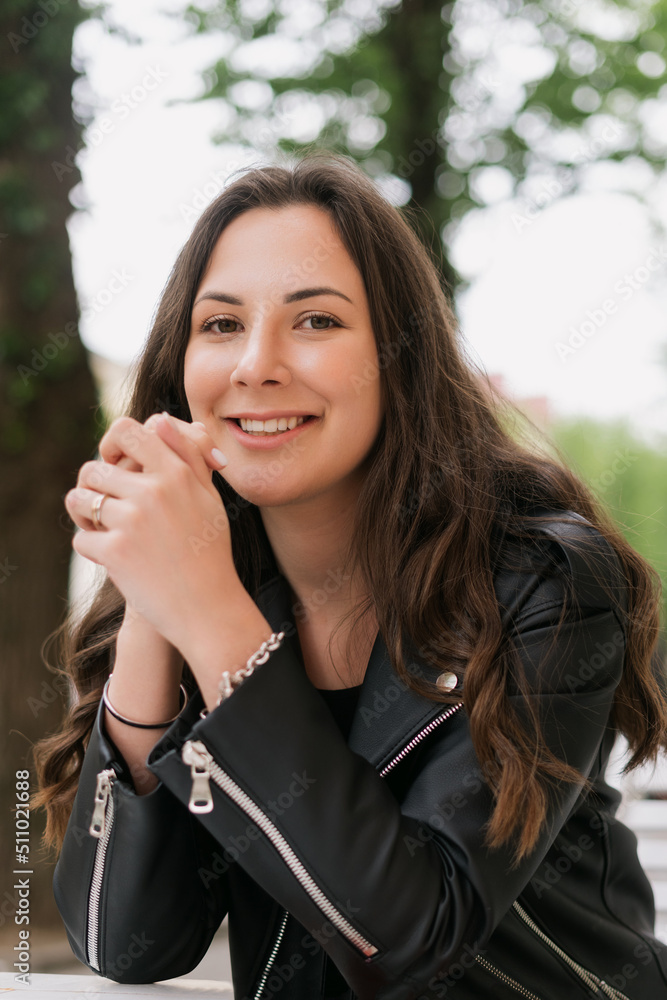 Portrait of a woman. A model in a leather jacket poses on the outside Portrait of a woman. A model in a leather jacket poses on the outside