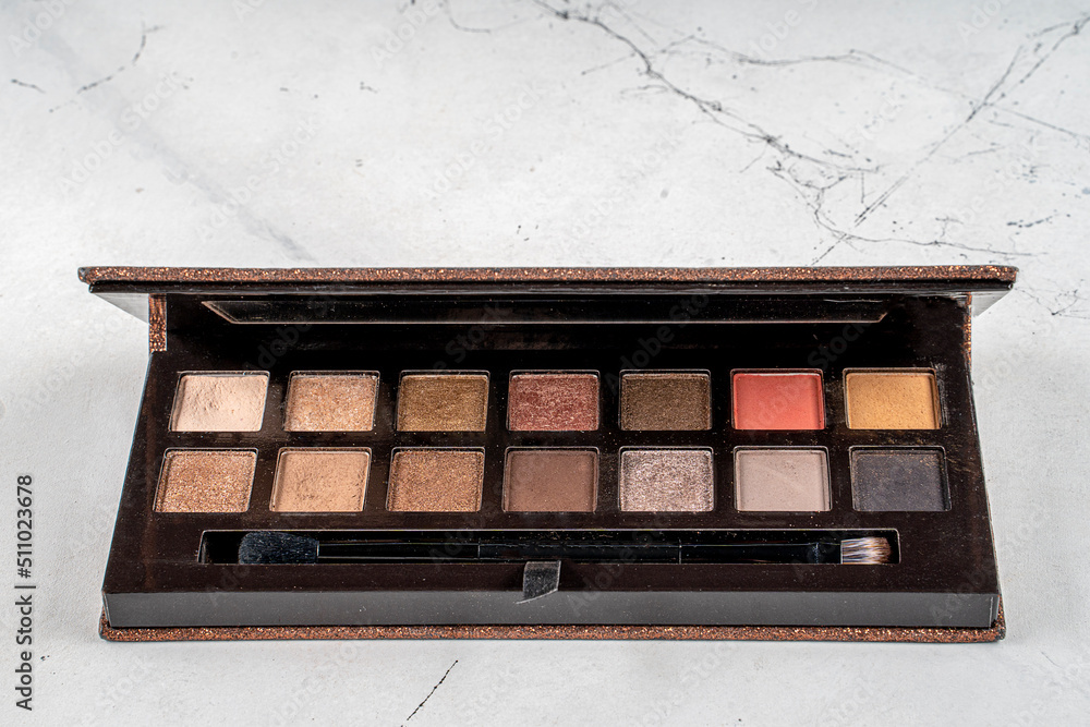 Cosmetic branding, girly concept - Large eyeshadow palette on marble background, eye shadows cosmetics as glamour make-up products for luxury beauty. Cosmetic branding, girly concept - Large eyeshadow palette on marble background, eye shadows cosmetics as glamour make-up products for luxury beauty.