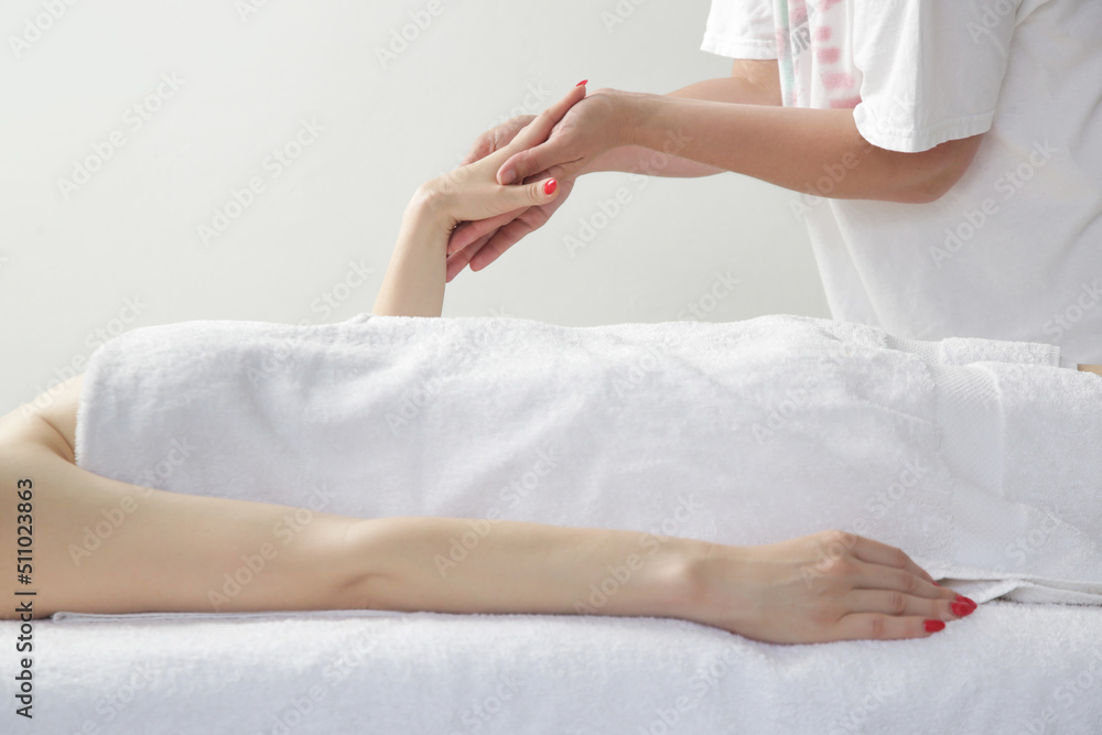 Arms massage. Young Caucasian woman enjoing soft shooting partial relax massage experience at spa salon. Arms massage. Young Caucasian woman enjoing soft shooting partial relax massage experience at spa salon.