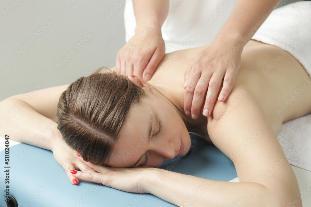 Spa massage outdoor. Mobile massage service. Young woman enjoing soft shooting relax massage experience at open fresh air treatment. Spa massage outdoor. Mobile massage service. Young woman enjoing soft shooting relax massage experience at open fresh air treatment.