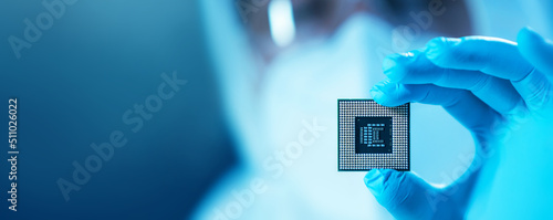 The scientist works in a modern scientific laboratory for the research and development of microelectronics and processors. Microprocessor manufacturing worker uses computer technology and equipment. photo