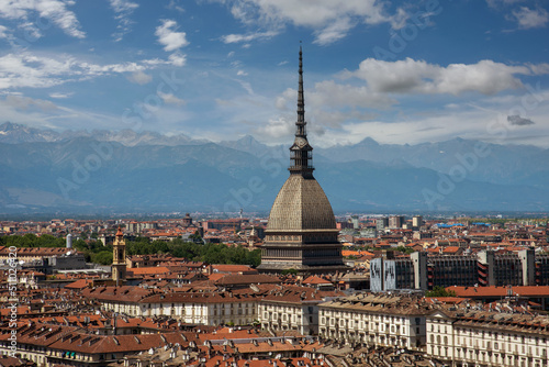 Turin  Piedmont  Italy - cityscape seen from above with the Mole Antonelliana architecture symbol of the city of Turin  in the background the Alps with blue sky with clouds