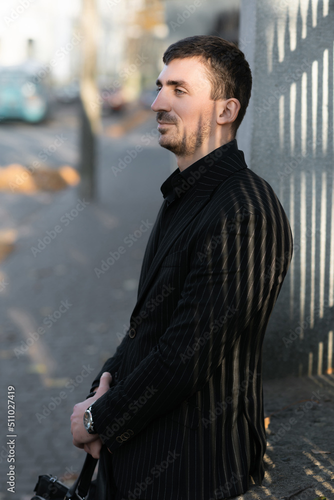 A cunning businessman on the street in anticipation of a bargain with a client. A cunning businessman on the street in anticipation of a bargain with a client.