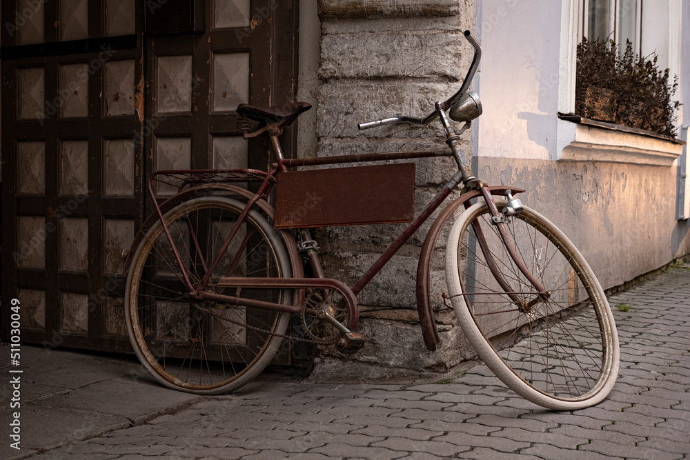Retro bicycle with house on the background. Old, cool, stylish, vintage, rusty bike. Beautiful, scenic, oldfashion, monochrome, like a movie scene. Summer vibe. Ecological, hipster transportation