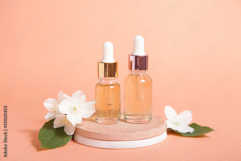 Minimal cosmetic background for product presentation. Cosmetic two bottle oil podium and flower on Pastel coral color background. Mock up Minimal cosmetic background for product presentation. Cosmetic two bottle oil podium and flower on Pastel coral color background. Mock up