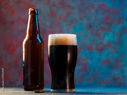 Wallpaper Mural glass of dark porter or stout beer on a blue background