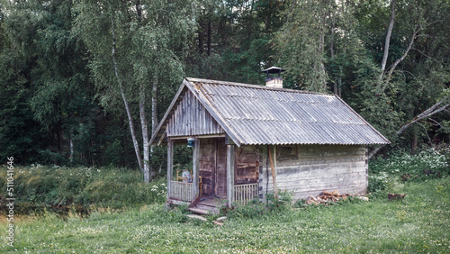 Old and abandoned bathhouse near the pond in meadow  country forest  Lithuania