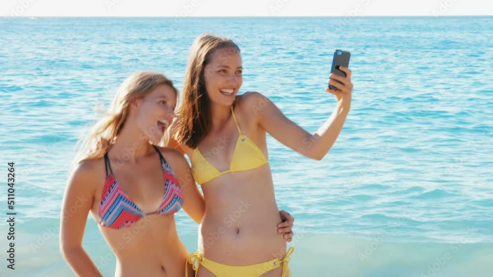 Animation of do it for them over happy caucasian female friends taking selfie on beach Animation of do it for them over happy caucasian female friends taking selfie on beach