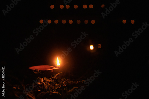 Diya in a diwali night with many Diyas in backround