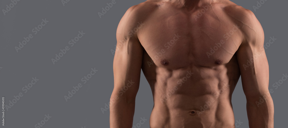 Man sexy bare torso, banner with copy space. He is in good shape. Shirtless guy in sports shorts. Fit guy grey background. Sporting man.