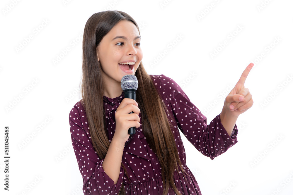 Pretty little girl singing with the microphone. Portrait of emotional amazed excited teen girl. Pretty little girl singing with the microphone. Portrait of emotional amazed excited teen girl.