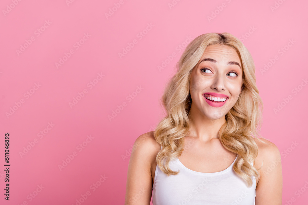 Portrait of attractive cheerful curious blond girl looking aside copy blank space ad isolated over pink pastel color background Portrait of attractive cheerful curious blond girl looking aside copy blank space ad isolated over pink pastel color background