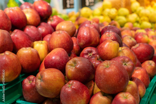 Close-up of delicious ripe red and yellow apples on the counter in the store. Sale of fruits at the market and in the supermarket