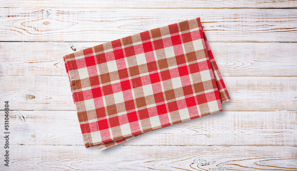 Obraz premium Folded towel, linen tablecloth on wooden desk top view.