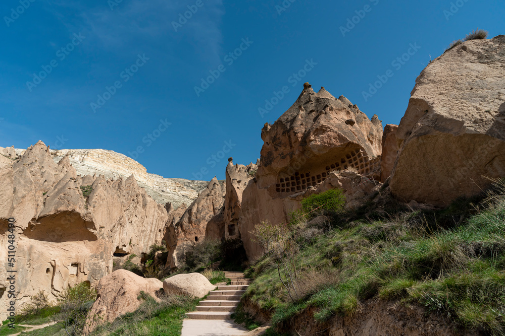 Fototapeta premium Selective focus on ancient cave underground city and Zelve open air museum in Cappadocia, Turkey.