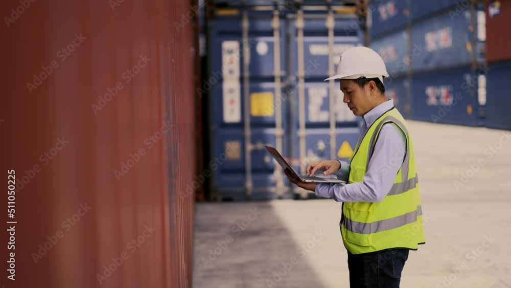 Container operator working on his laptop to process his routine inspection task on a container yard. Container operator working on his laptop to process his routine inspection task on a container yard.