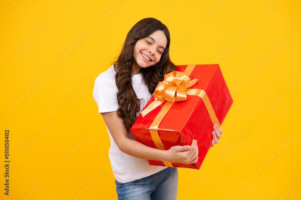 Portrait of teenager child girl 12, 13, 14, years old holding Christmas gift box. Teen giving birthday gift. Portrait of teenager child girl 12, 13, 14, years old holding Christmas gift box. Teen giving birthday gift.