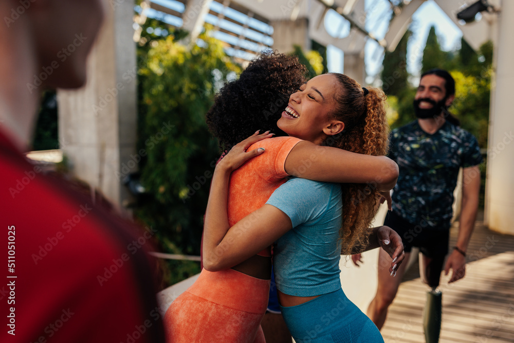 Athletes hugging after successful workout Athletes hugging after successful workout