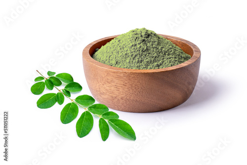 Moringa leaf (Moringa Oleifera) and moringa powder in wooden bowl isolated on white background. photo