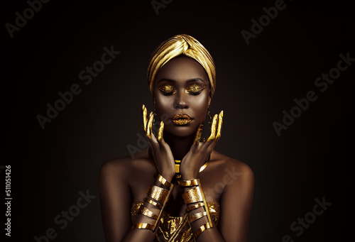 Slika na platnu Portrait closeup Beauty fantasy african woman face in gold paint