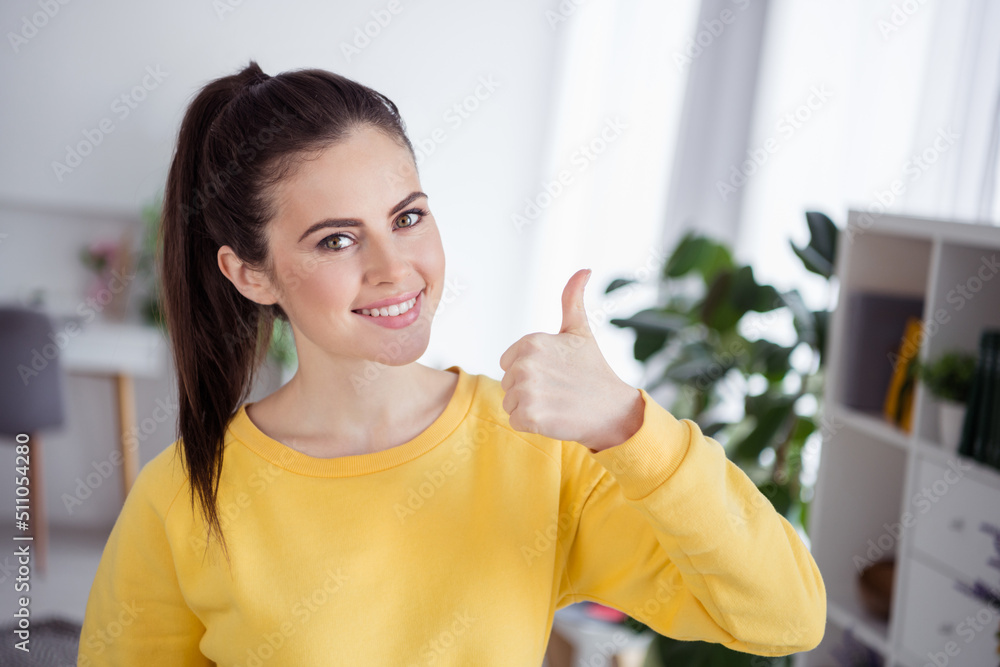 Photo of cheerful nice lady toothy smile arm demonstrate thumb up yes quality indoors