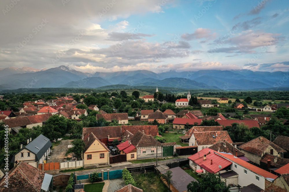 Obraz premium Transylvanian old village of Porumbacu photographed from drone with Fagaras mountains in the background