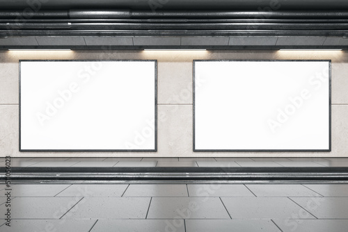 Fototapeta Naklejka Na Ścianę i Meble -  Front view on two blank white billboards in black frame with empty space in undeground area with dark ceiling and grey floor. 3D rendering, mock up