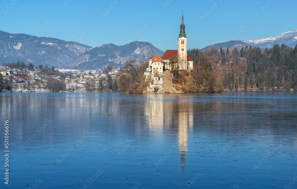 Lake Bled on a cold winter day with frozen ice. Icy water on the lake. 