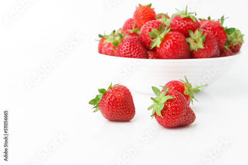 Red ripe strawberry in the white bowl  isolated