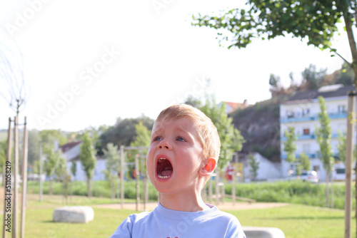 Картината върху платно A blond boy with his mouth wide open and his face red
