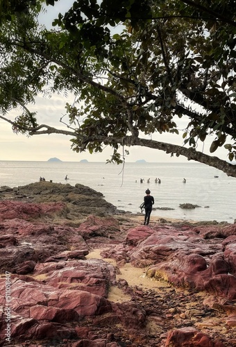 scene at the rocky beach with peopke photo