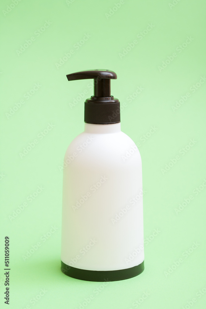 Plastic soap bottle with black bottom and top on green background. Plastic soap bottle with black bottom and top on green background.
