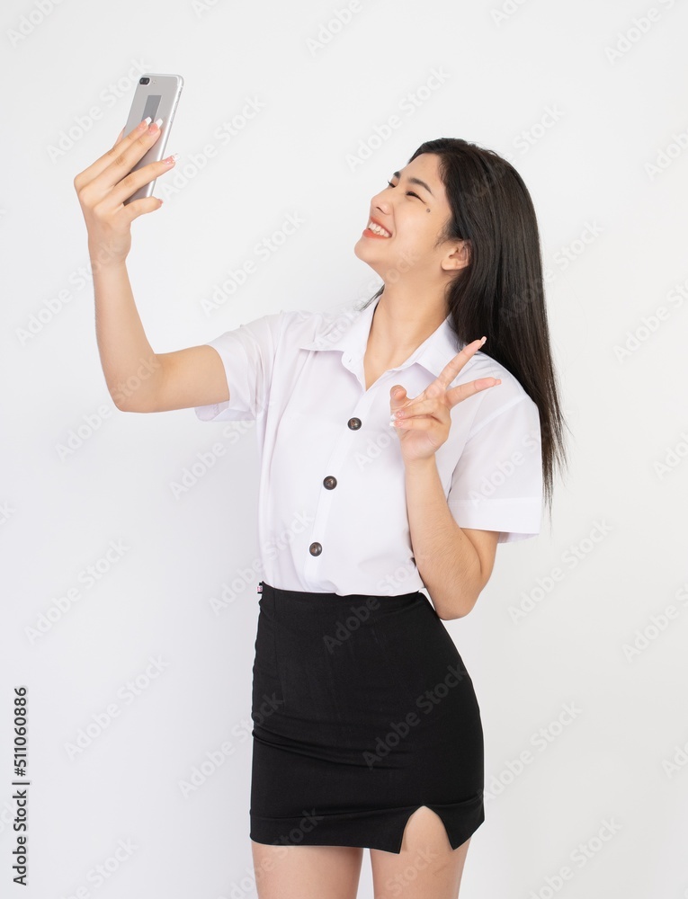 Portrait of a beautiful young asian female lady university student in happy mood video call and chat talking to her friend on a smartphone Portrait of a beautiful young asian female lady university student in happy mood video call and chat talking to her friend on a smartphone