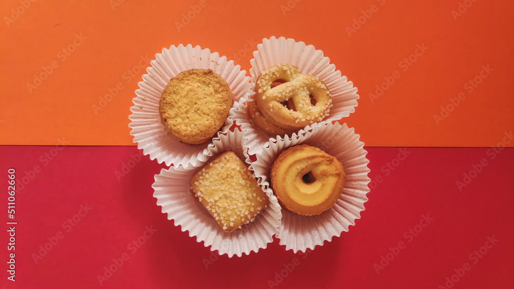 shapes of cookies in stack on red background