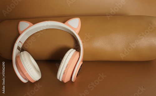 Pink and white headphones on colored background. Music concept. 